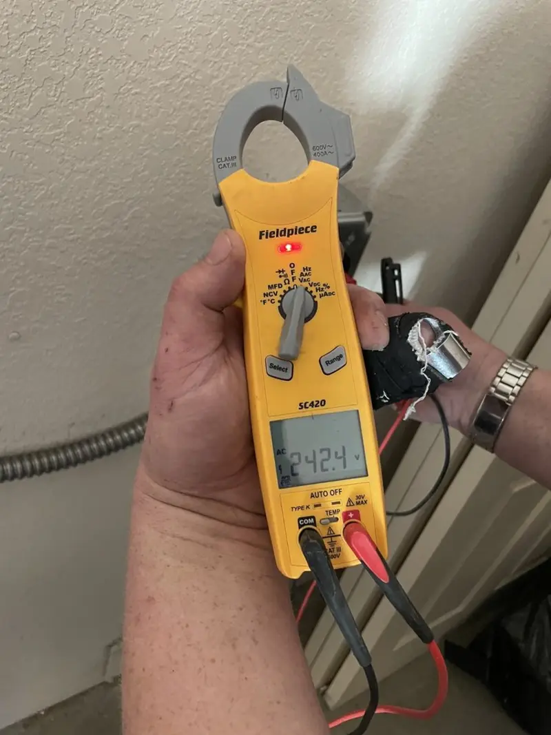 Voltage testing with clamp meter during Electrical Installation Services in Spanish Fort